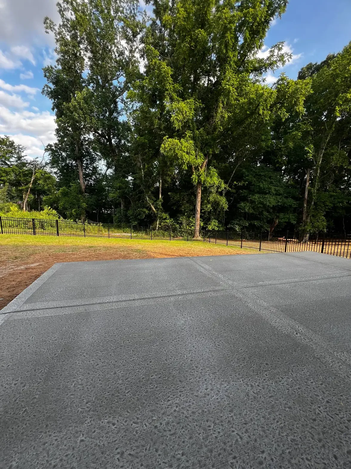 Concrete patio pad with broom finish and ornamental fence — Clarksville TN