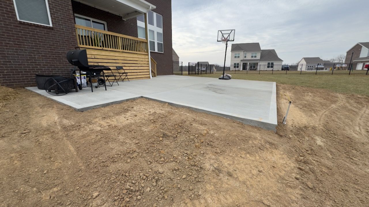 Freshly poured concrete patio extension with control joints in Clarksville, TN